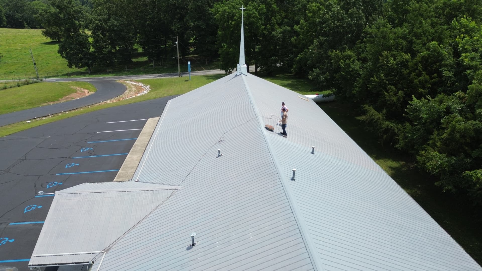 Aerial view of our crew restoring a church metal roof